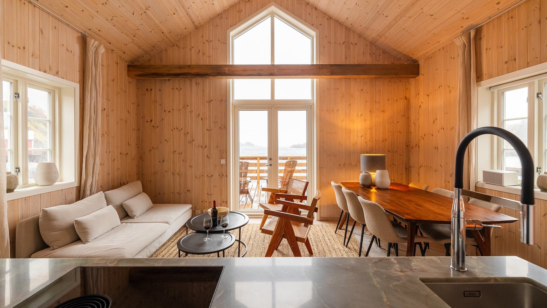 Luxury cabin interior with wood-panelled walls and fjord views